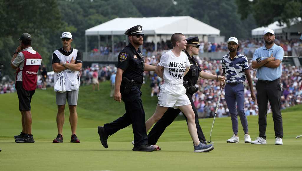 Six climate protesters run onto 18th green and spray powder, delaying finish of PGA Tour event [Video]