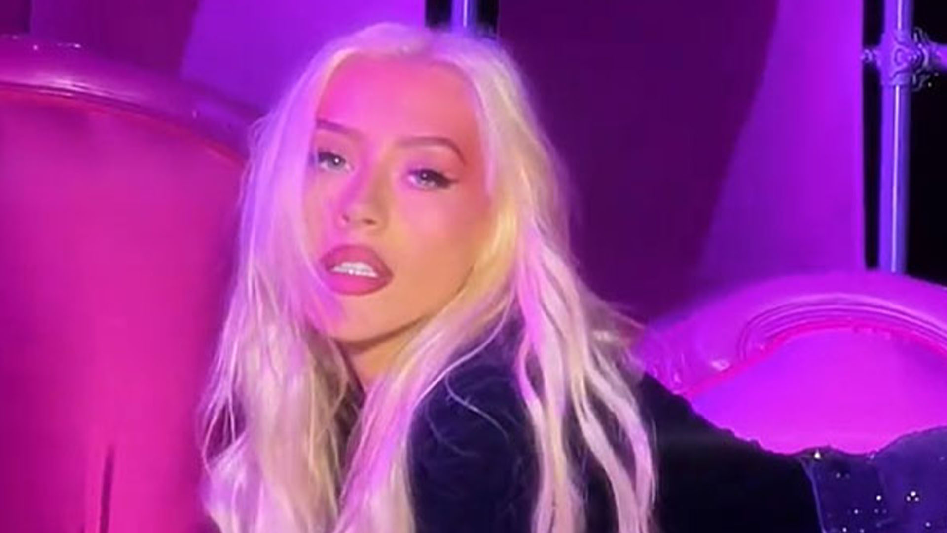 Christina Aguilera looks slimmer-than-ever as singer rolls around on couch in a mini skirt after 40lb weight loss [Video]